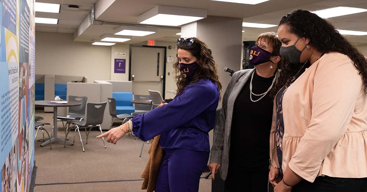 Dean of Students Minnette Ellis views the sesquicentennial mural in Collier Library with Vice President of Student Affairs Kimberly Greenway and General Counsel Amber Fite-Morgan.